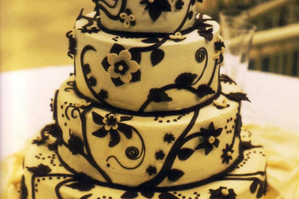 Handmade custom chocolate designs decorate this Italian Buttercream wedding cake
