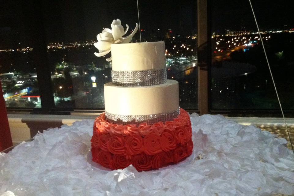 A 3 tier Nashville Wedding Cake covered in fondant,surrounded in  burlap ribbon