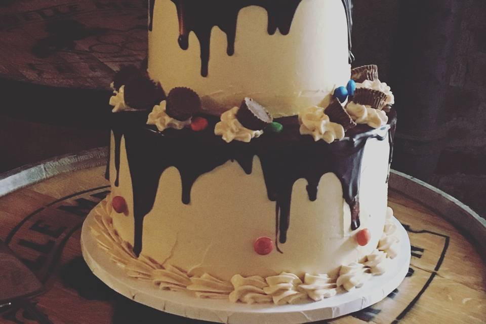 2 tier chocolate peanut butter grooms cake frosted with peanut butter butter cream and dripping with chocolate ganache