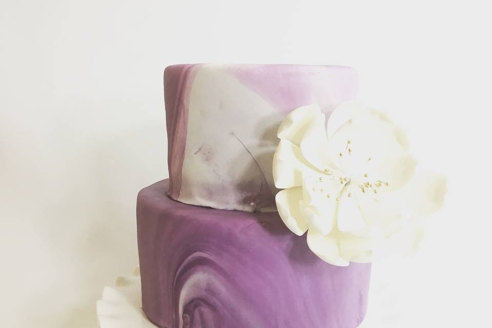 A 2 tier purple marble color fondant cake great for Nashville wedding