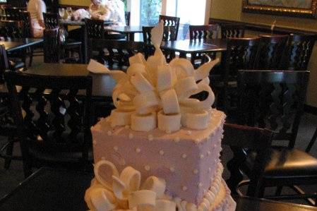 A devine combination of shapes and textures, this cake is accented with pretty bows.