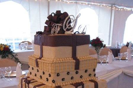 Chocolate cake covered with ivory buttercream and chocolate embellishments creates a stunning wedding cake.