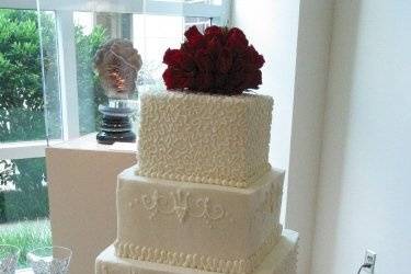 An all-white, all buttercream design using today's popular square tiers.