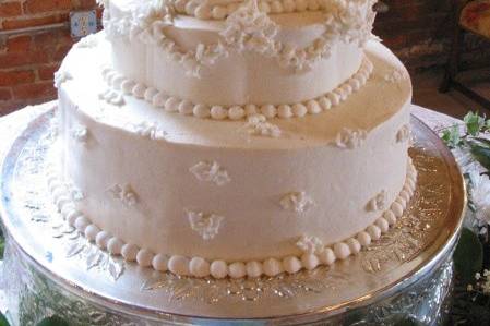 A combination of round, petal, and hexagon shapes, these white buttercream tiers are graceful and elegant.