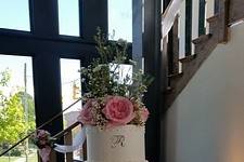 Fresh heirloom roses on a five-tier buttercream cake create an elegant focal point at 701 Whaley.