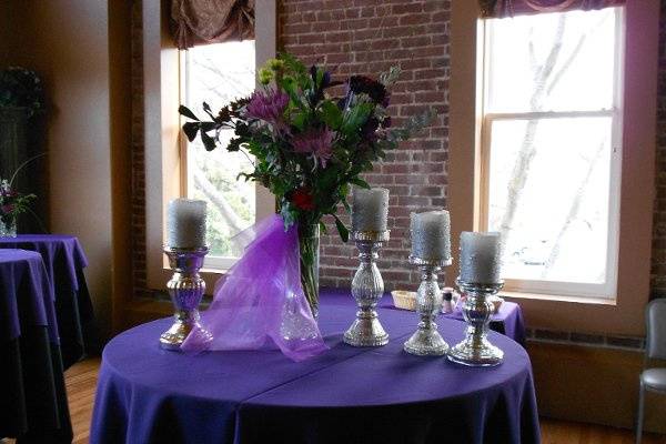 Table we sometimes put in between buffet tables, decorated with pretty flower arrangement & candles in the front room