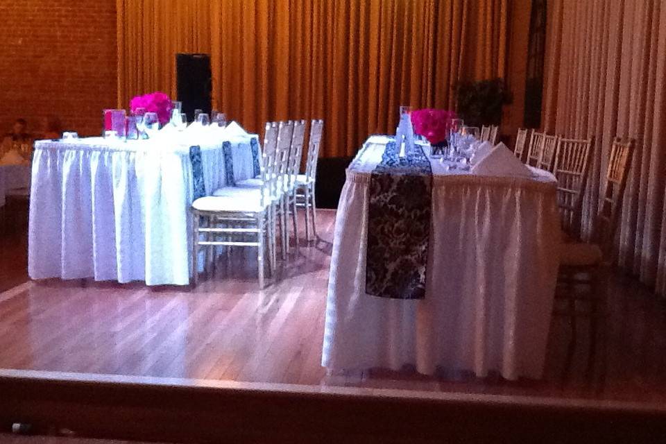 Bridal party tables on stage.