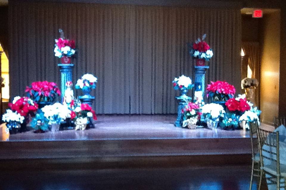 2 days before Christmas ceremony and reception. Ceremony on the stage with lots of Poinsettias. Very pretty!